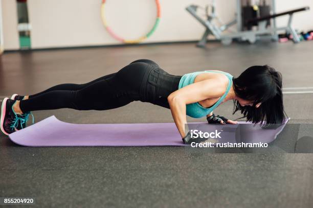 Fit Girl Doing Exercises On The Floor In The Gym Stock Photo - Download Image Now - Adult, Aerobics, Anaerobic Exercise