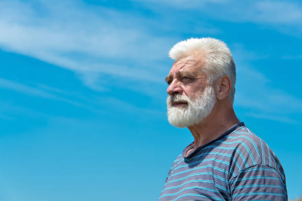 istock Portrait of a retiree on a blue sky background. 855205258