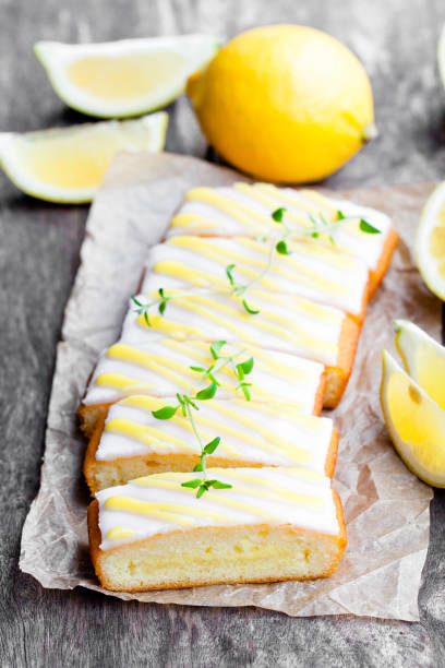 istock Lemonloaf  cake sliced on baking paper with green herb tea 855205486