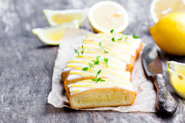istock Lemonloaf  cake sliced on baking paper with green herb tea 855207934