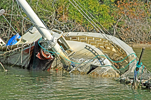Rotting abandoned sunken sailboat half in water perdido key fl pirates cove alabama