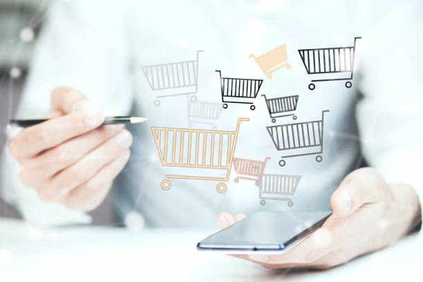 istock man hand phone with shopping basket 855224340