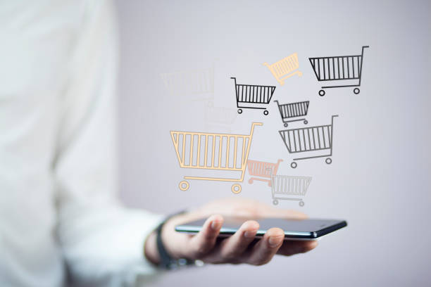 istock man hand phone with shopping basket 855224352