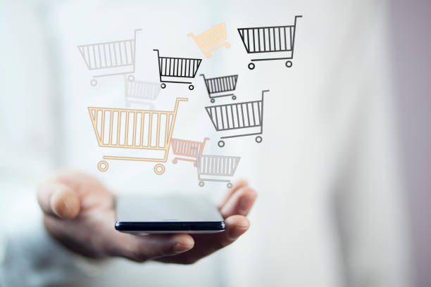 istock man hand phone with shopping basket 855224376