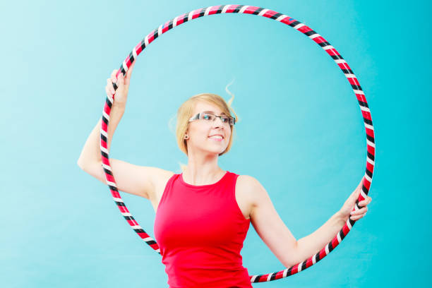 istock Fit woman with hula hoop doing exercise 855227532
