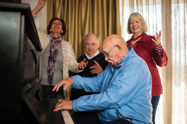 istock Seniors at a piano singing loud together 855227578