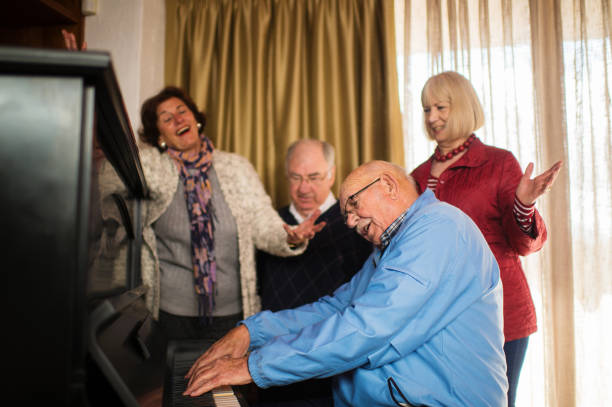 istock Seniors at a piano singing loud together 855227580