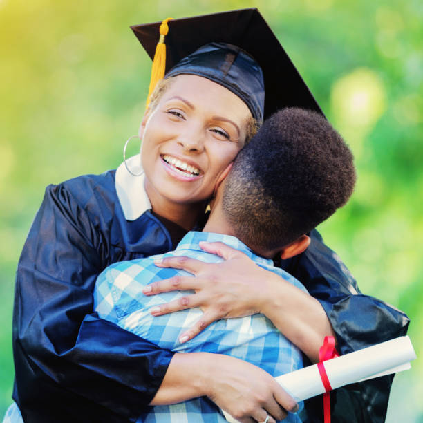 istock Beautiful female graduate hugs young son after ceremony 855227630