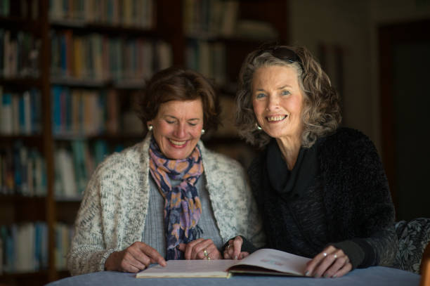 istock Friendly Senior Ladies reading a book together 855230242