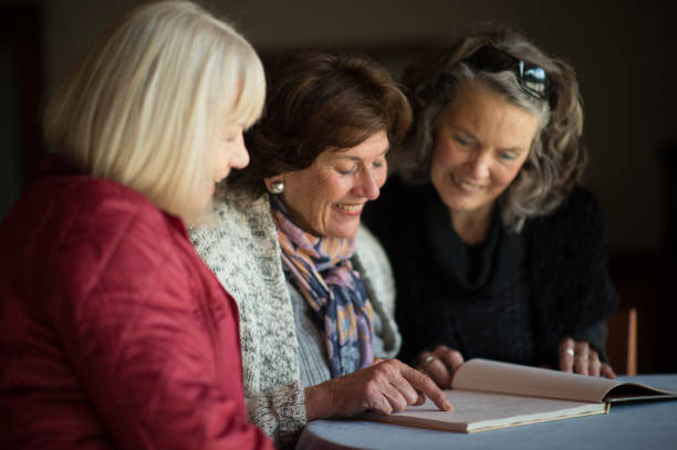 istock Friendly Senior Ladies reading a book together 855230686