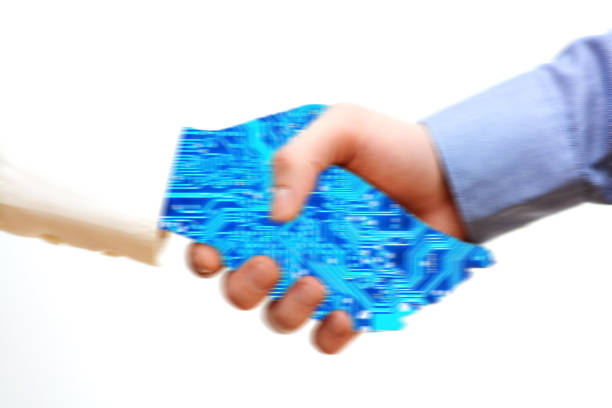 istock Technology versus human interaction concept with robot arm shaking hand with human 855235874