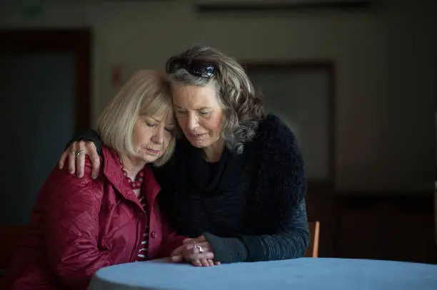 Photo of Two senior ladies supporting one another