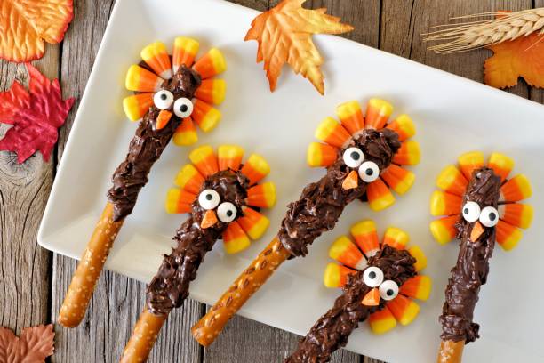 Candy corn turkey pretzel rods on a white plate Thanksgiving candy corn turkey pretzel rods on a white plate, overhead scene funny thanksgiving stock pictures, royalty-free photos & images