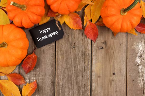 istock Happy Thanksgiving chalkboard tag with autumn corner border over wood 855242588