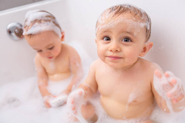 istock Two little boys having fun with water by taking bath in bathtub 855246494