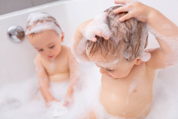 istock Two little boys having fun with water by taking bath in bathtub 855246536