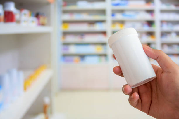 istock pharmacist with medicine bottle at the pharmacy 855256812