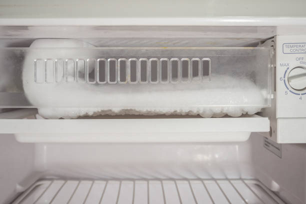 istock frozen Ice buildup in the freezer of refrigerator 855256856