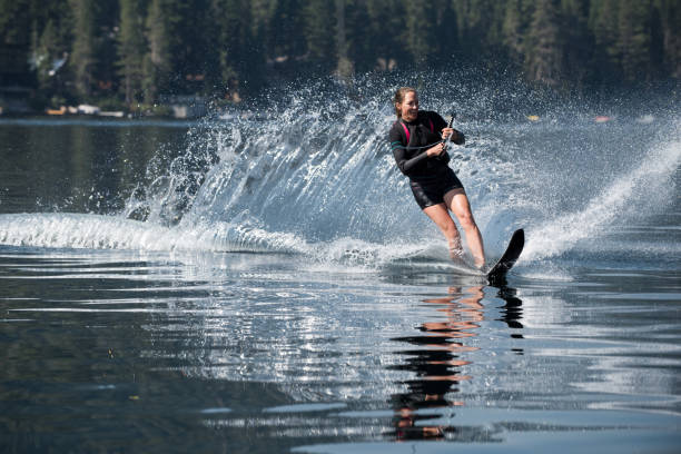 istock Beautiful woman waterskiing 855256938