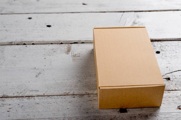 istock Cardboard box on a wooden background 855257208