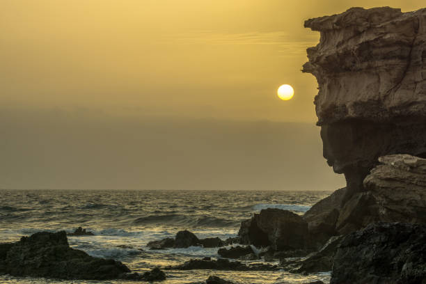 istock a great rock in the sea at sunset 855263178