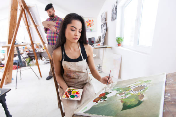 istock Couple painters working in atelier 855269524