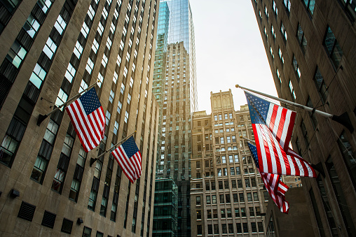 Skyscrapers in midtown Manhattan with American flags, New York City, USA