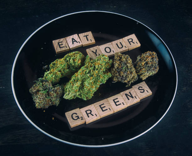 Plate with cannabis buds on black - infused medical marijuana concept - fotografia de stock