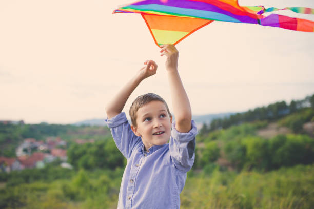 istock Boy flying kite outdoors 855281358