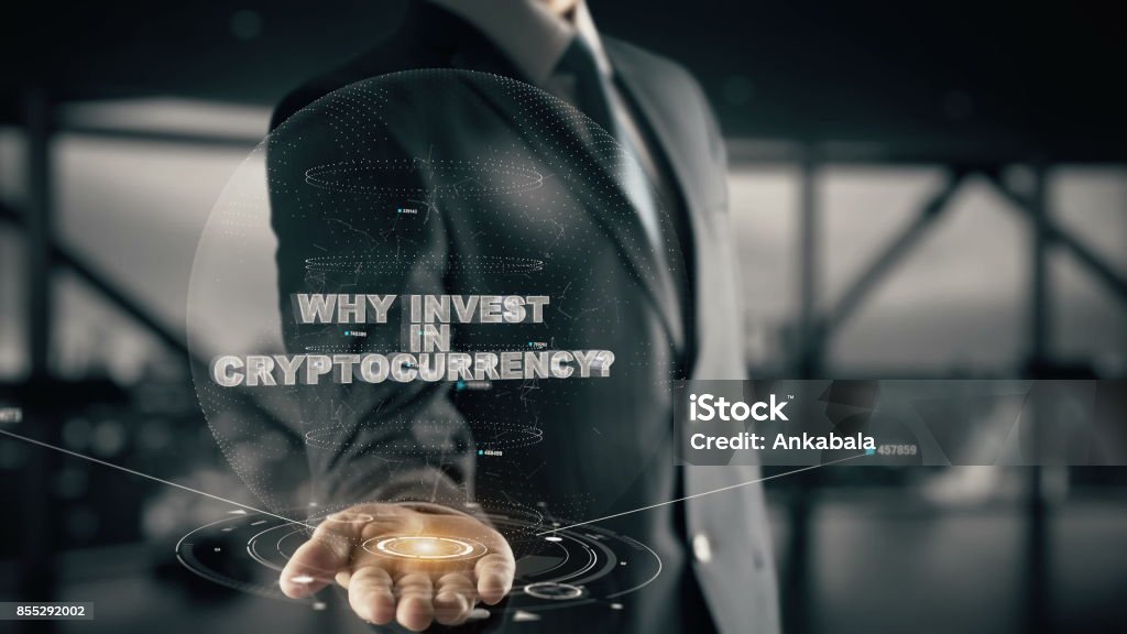 Why Invest in Cryptocurrency_150 with hologram businessman concept Business, Technology Internet and network concept Cryptocurrency Stock Photo