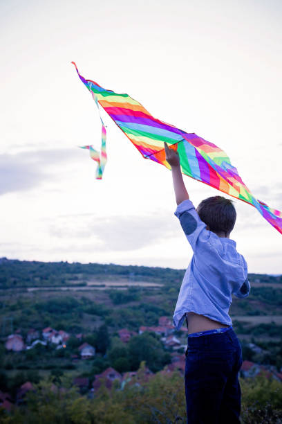 istock Child raising his arm with a kite in it 855295368