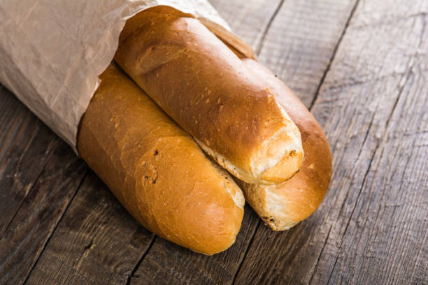 istock Baguettes on wooden table 855310440