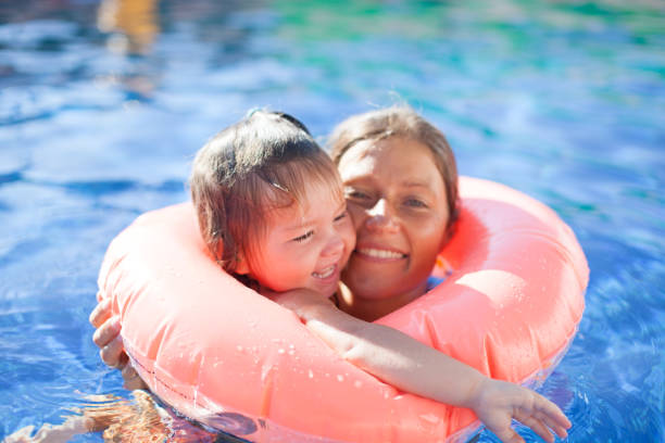 istock happy mother and daughter in swimming pool 855313452