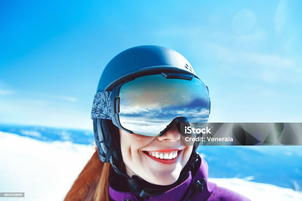 woman in mountain goggles Portrait of a Woman in the Alps in Glasses Ski Goggles Stock Photo