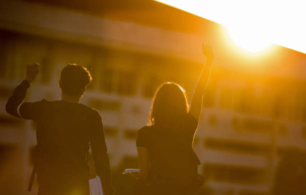 Students are glad they completed the final exam.lens flare