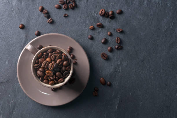 istock Coffee cup full of beans 855318654