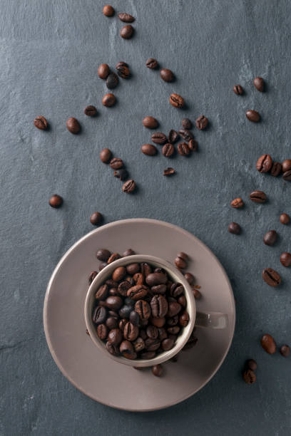 istock Coffee cup full of beans 855318694