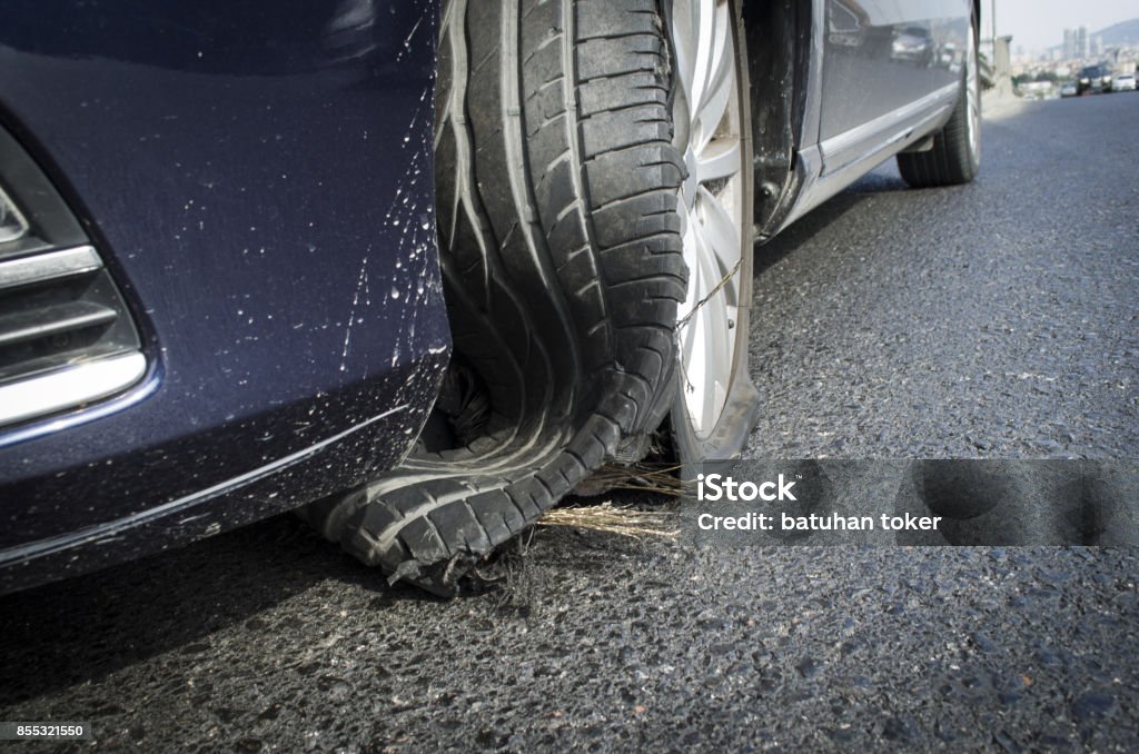 damaged tire after tire explosion at high speed on highway Tire - Vehicle Part Stock Photo