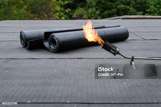 Heating And Melting Bitumen Roofing Felt Flat Roof Installation Stock Photo - Download Image Now