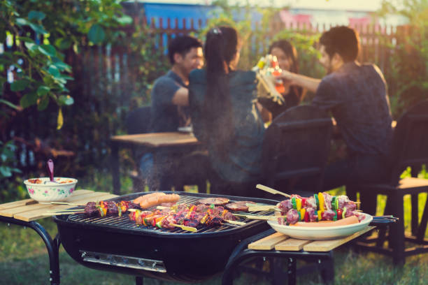 istock Dinner party, barbecue and roast pork at night 855322960