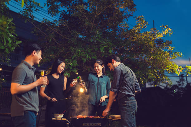 dinner party, barbecue and roast pork at night - group of objects travel friendship women imagens e fotografias de stock