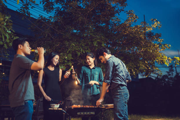 istock Dinner party, barbecue and roast pork at night 855323142