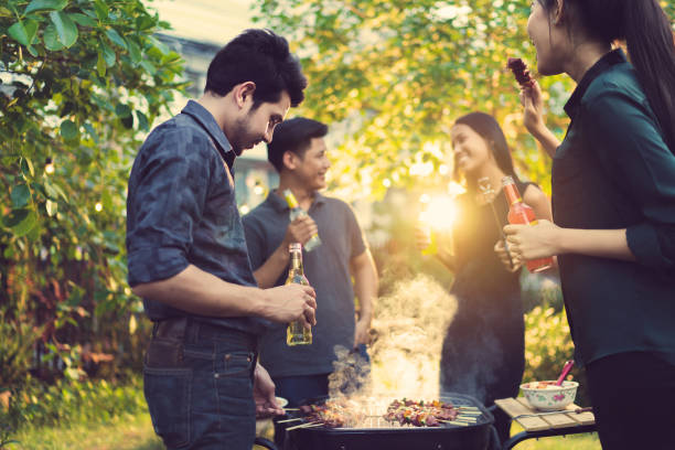 istock Dinner party, barbecue and roast pork at night 855323228