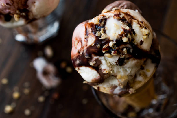 istock ice cream in glass with chocolate sauce and hazelnut. 855325930