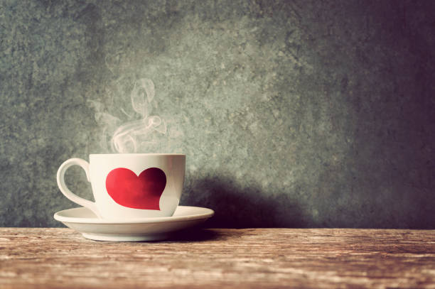 istock Hot coffee in a cup on wooden table and cement wall background 855327032