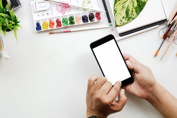 istock White office desk table man using mobile phone with a lot of things on it. Top view with copy space. 855330494