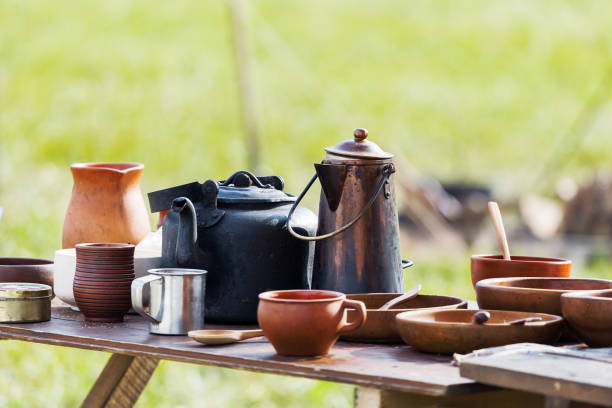istock Wooden table with old fashioned wooden and earthenware crockery. Historical reconstruction of 19 century. 855331114