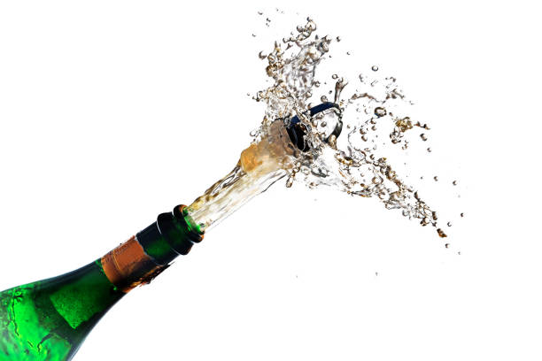 istock champagne bottle explosion with cork popping splash isolated against a white background, copy space, selected focus, motion blur 855333678