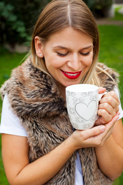 istock Woman holding a cup of coffee 855333916