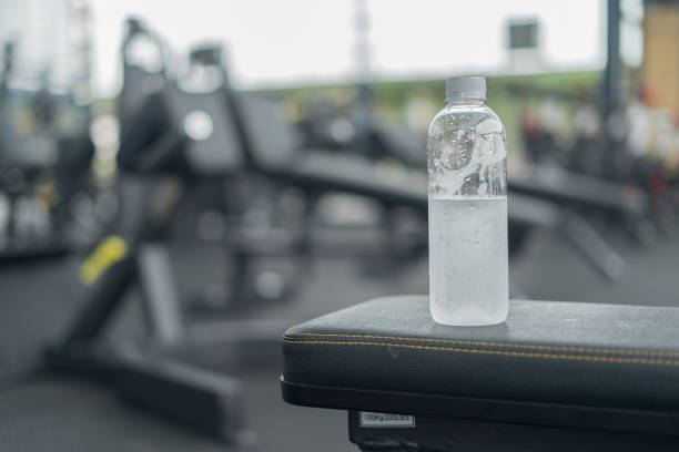 istock Fitness background with bottled water in gym 855334158